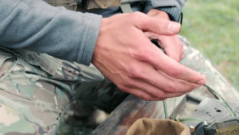 soldier loads ammunition into the pistol holder. preparation for military action