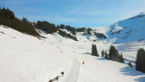 Drone-view-French-alps-from-a-chairlift,-high-angle-in-Flaine,-France