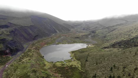 Lagoa-do-Peixe,-one-of-the-smallest-lagoons-in-São-Miguel-Island,-Azores---Aerial-pull-out-fly-over