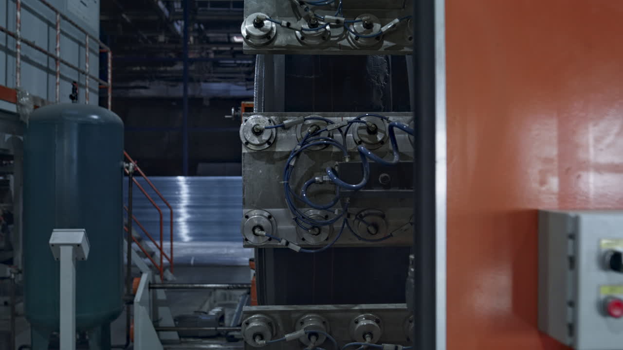 Car tyre manufacturing machine with background worker working at factory