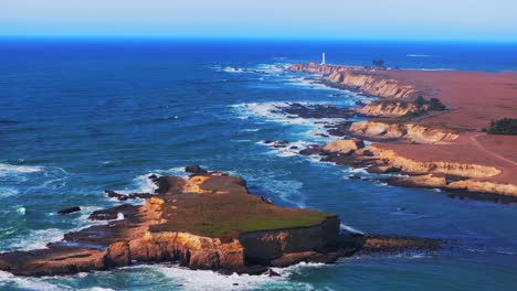 aerial view of dramatic coastline with lighthouse