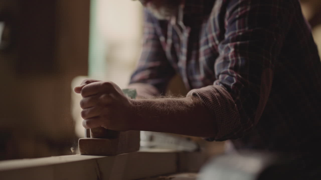 Woodworker Shaping Wood with Tool