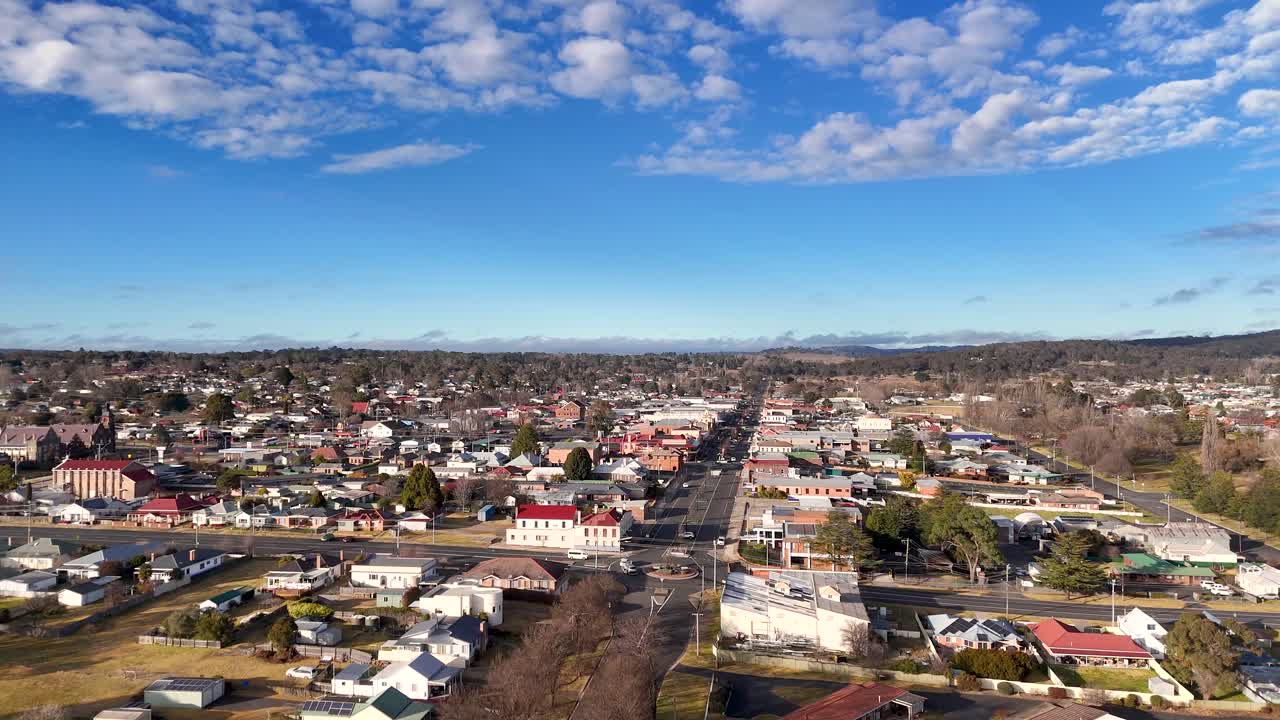 Urban residential area with traffic, buildings, and blue sky