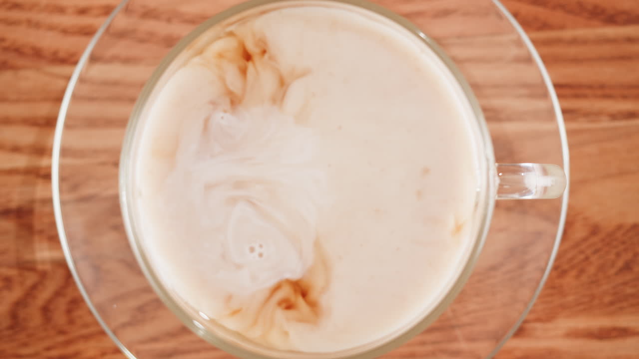 Pouring milk into a cup of hot tea