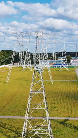 long-range energy high voltage transmission. electric transformers wires and grid. vertical video