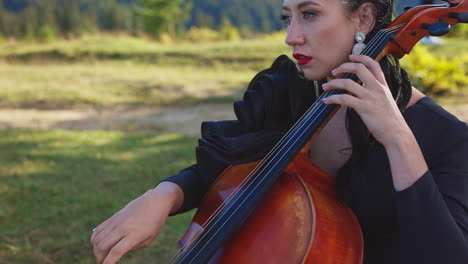 woman playing cello outdoors