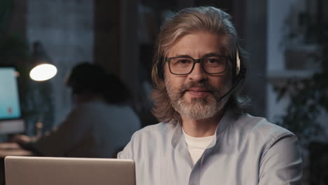 call center agent working on laptop with headset and laptop