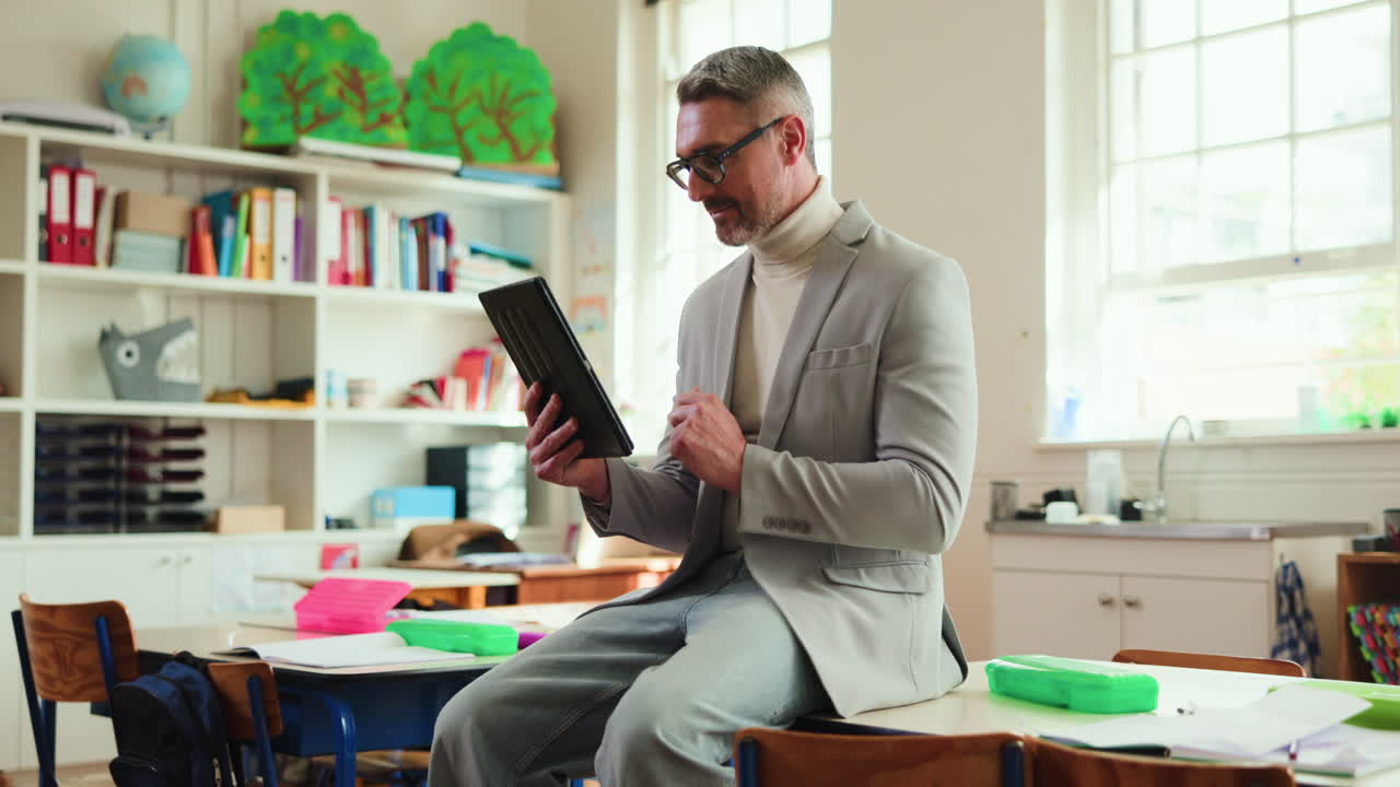 Teacher in Classroom Using Tablet