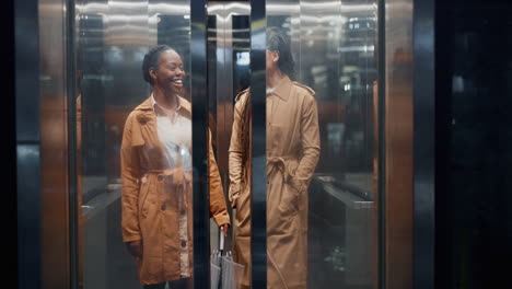 Elevator, business women and conversation