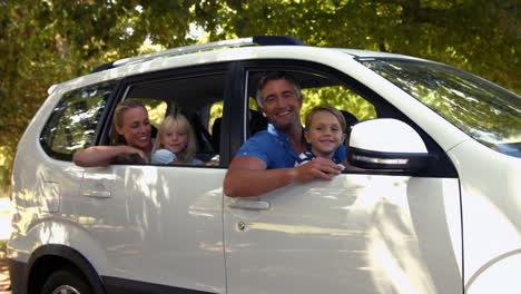 happy family getting ready for road trip and looking at camera