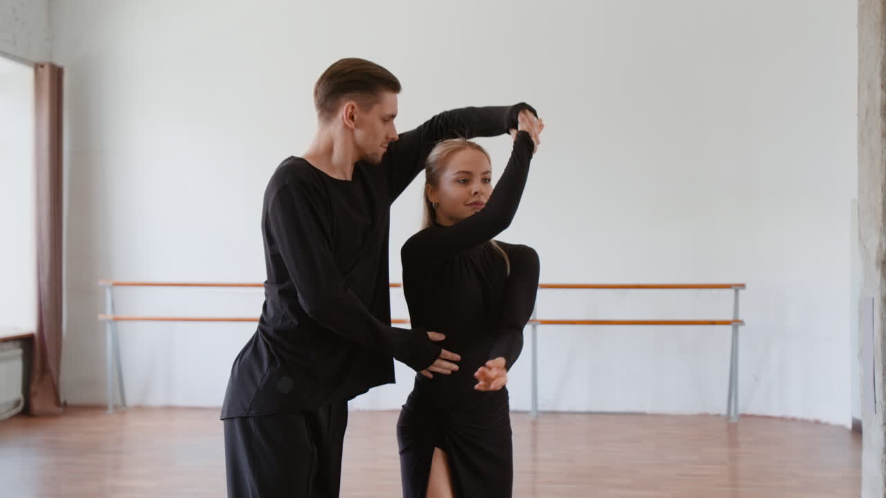 Couple practicing dance choreography in a studio