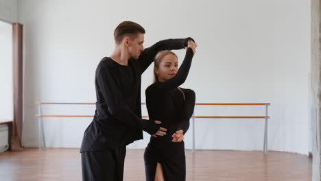couple practicing dance choreography in a studio