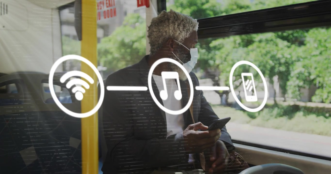 Animation of application icons over senior african american man wearing mask and using cellphone
