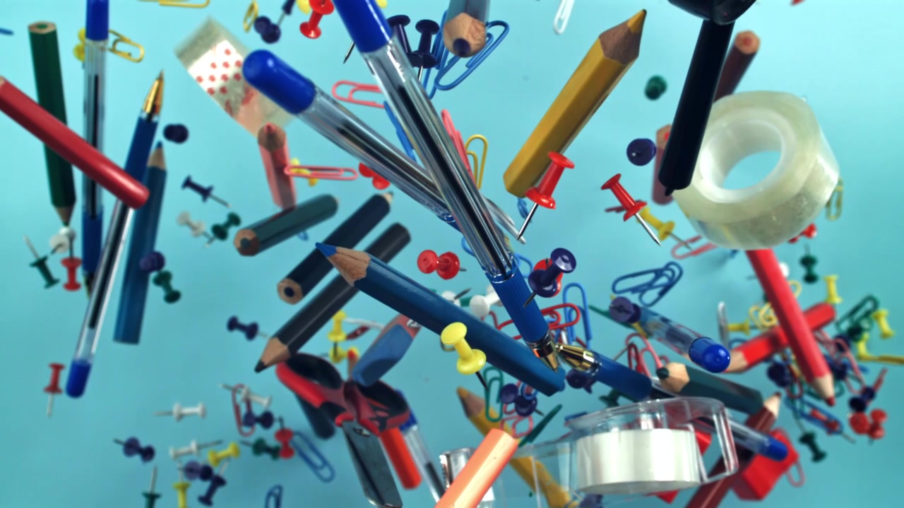 Colorful Office and School Supplies Floating on Blue Background