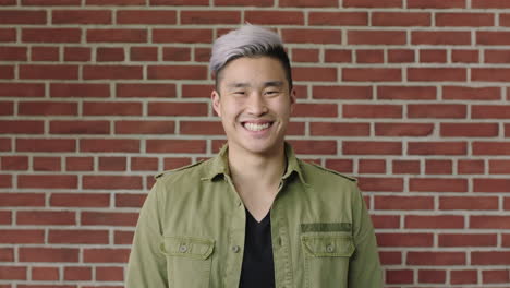 portrait of young asian man student smiling confident at camera