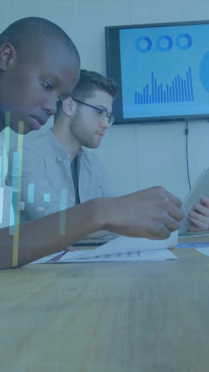 Animation of graphs moving over diverse colleagues analyzing sales report on desk in meeting