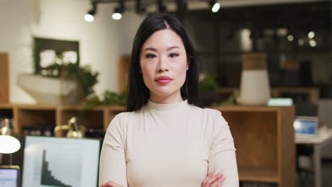 video of happy asian woman looking at camera in office