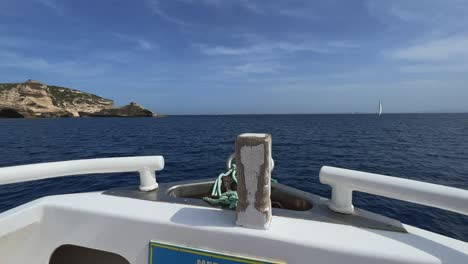 Fpv-on-bow-of-sailing-boat-along-Bonifacio-cliffs-and-coast-of-Corsica-island-in-France,-first-person-view-at-50fps