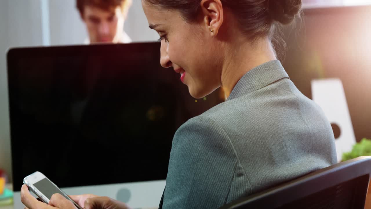 Businesswoman using mobile phone in office