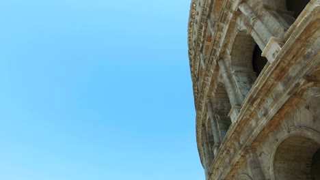 ruins of the colosseum in rome, italy against blue sky