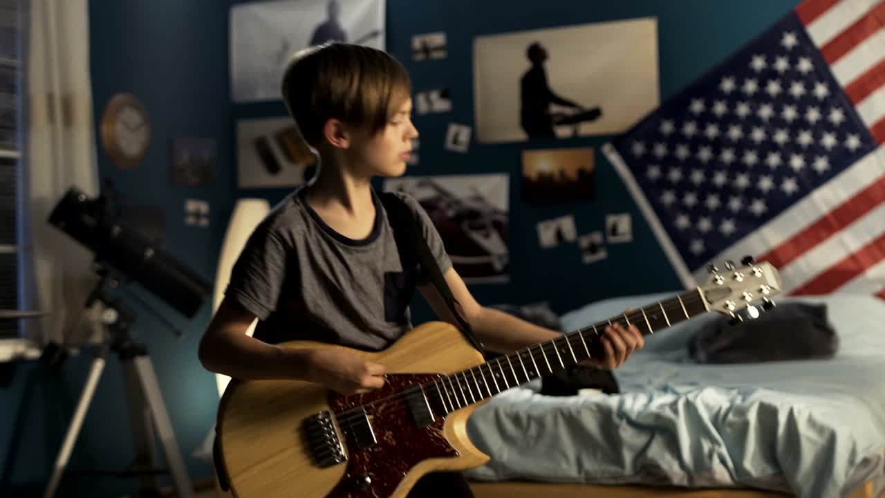 joven con guitarra en el dormitorio