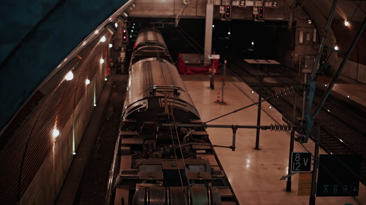 Train moving through the Monaco train station with bright lights