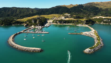 golden bay of new zealand with moored boats, aerial drone view