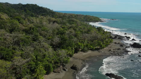 elevated shot of costa rican shores with greenery and rocks.