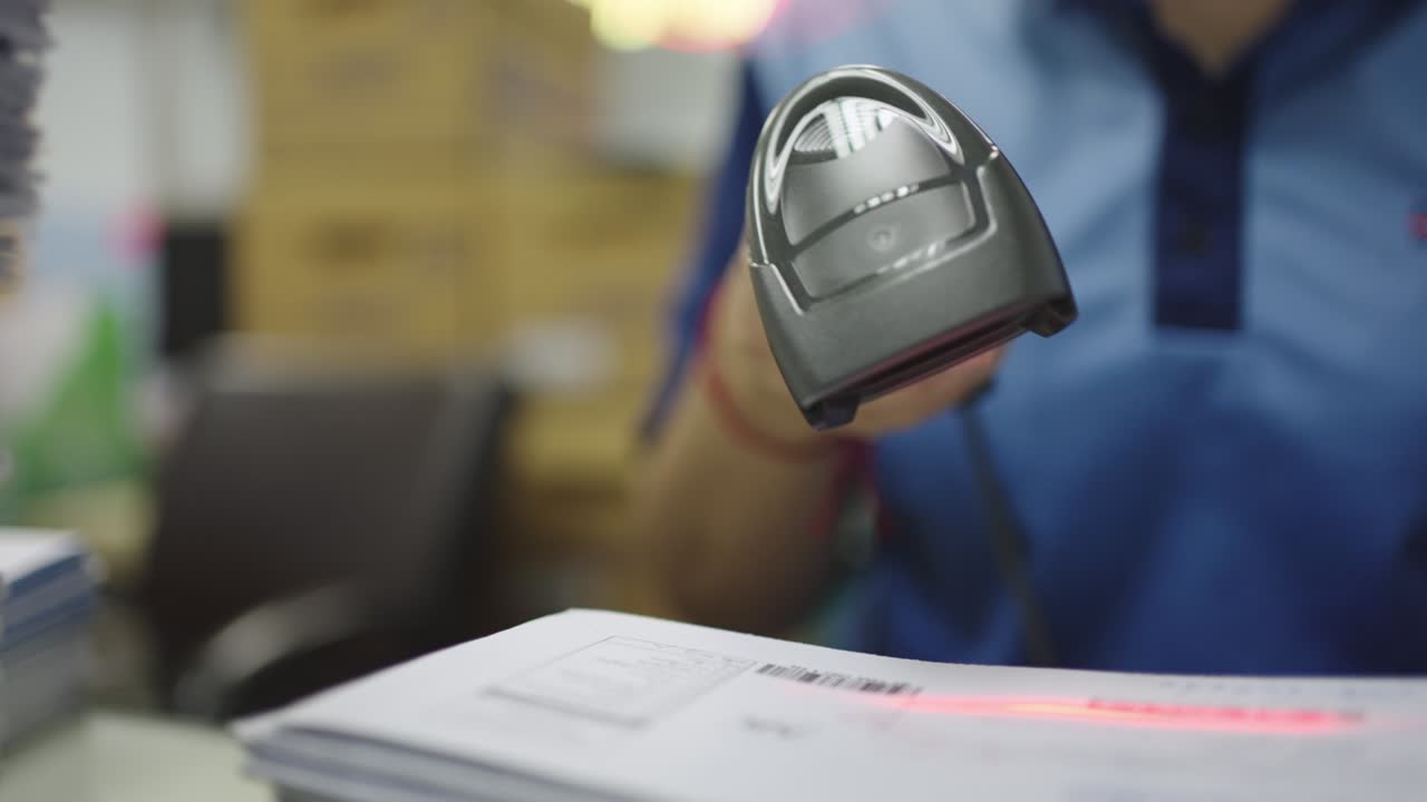 Close-up, Hand of woman using barcode reader scan barcode for convert data into digital computer.