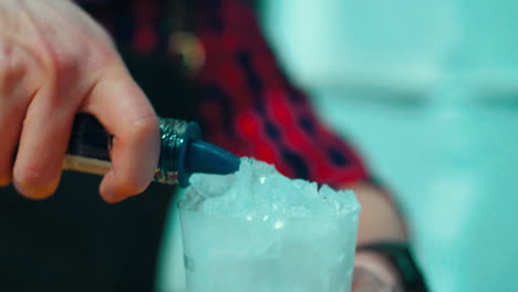 man preparing cocktail at cocktail glass at bar. preparation of refreshing drink