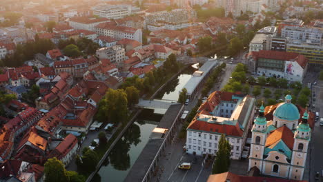mesarski footbridge over ljubljanica river and baroque church of ljubljana in slovenia