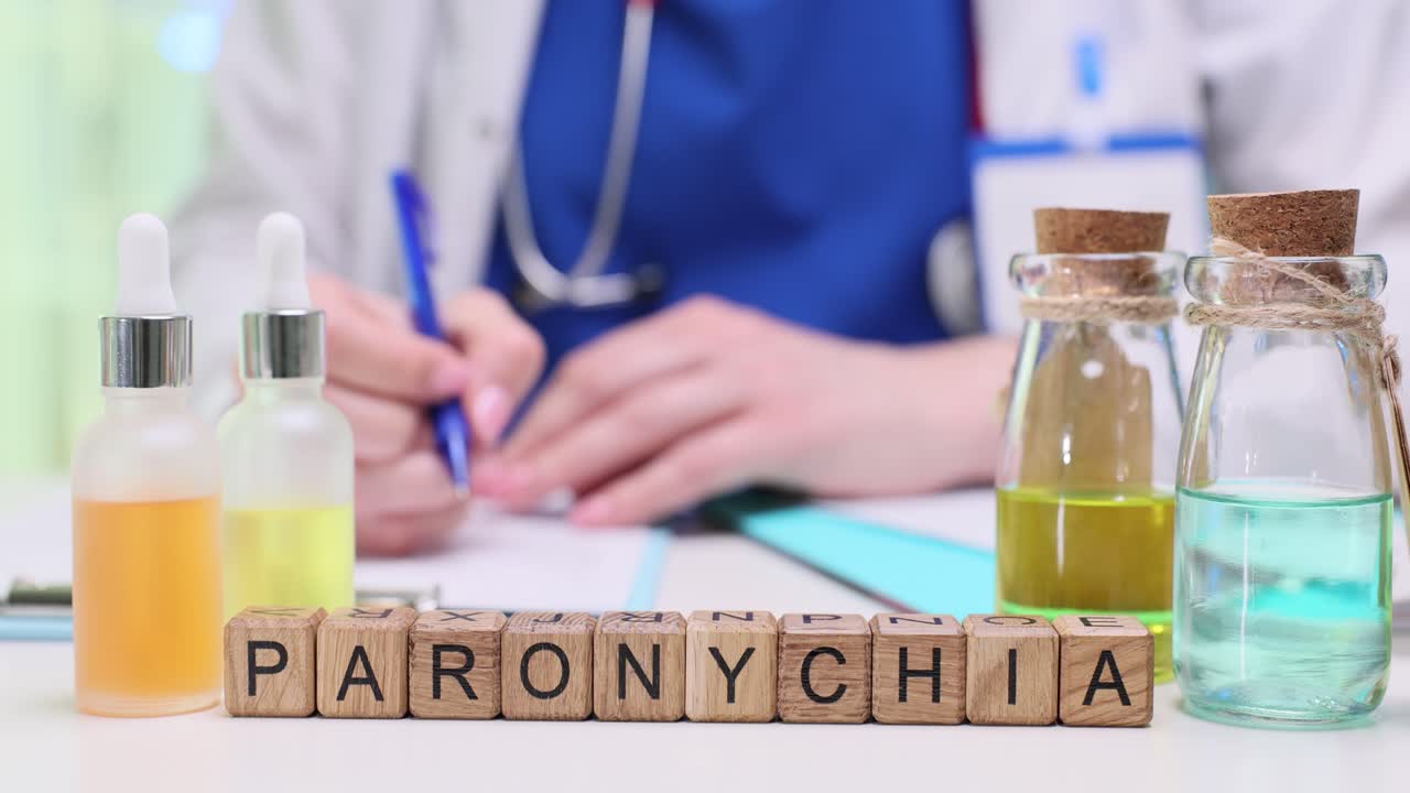 Medical bottles and wooden blocks spelling Paronychia with a healthcare professional in the background
