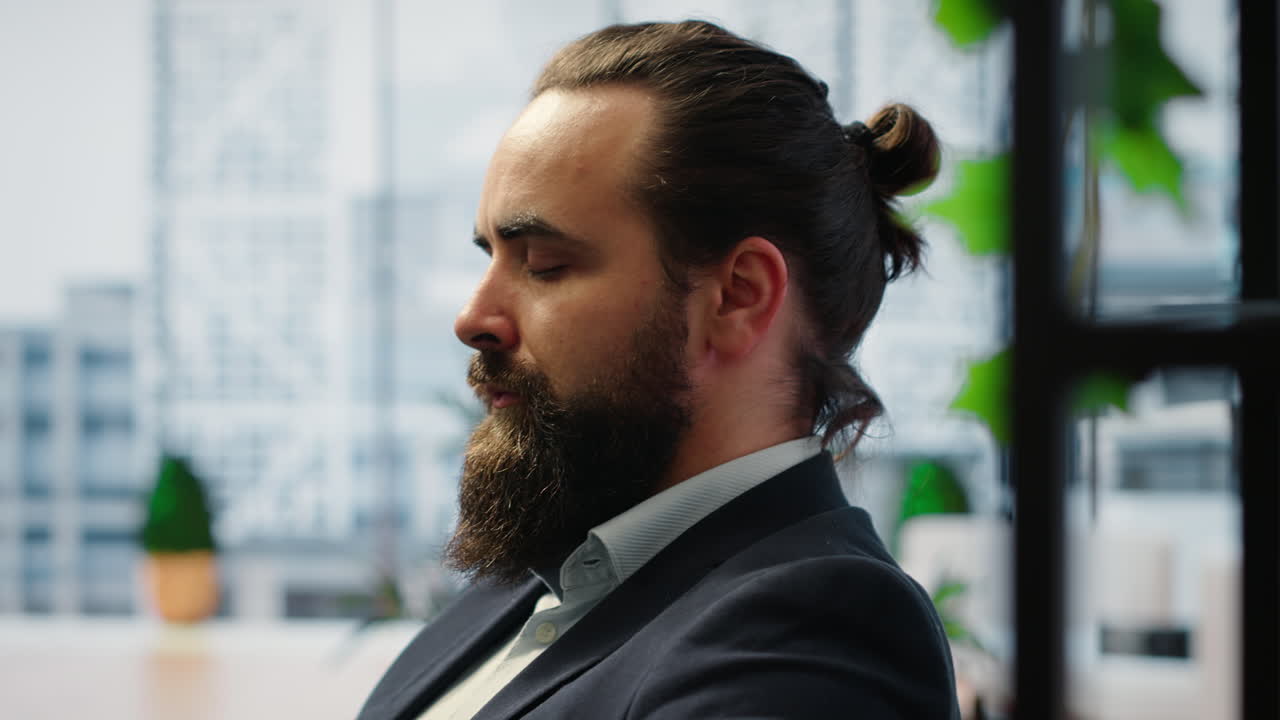 Vertical Video CEO leans back in his office chair engaging in a guided meditation session