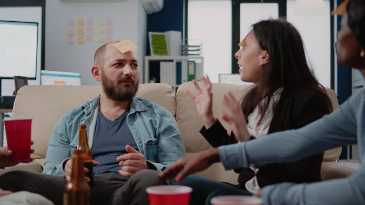 Multi ethnic group of workers playing charades to guess