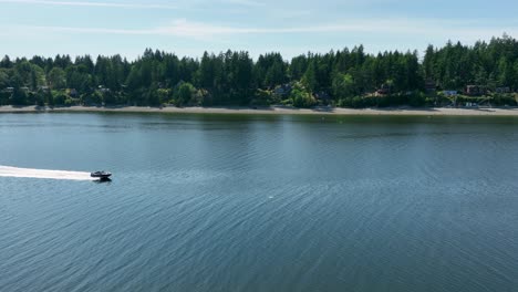 Aerial-view-of-a-motorboat-speeding-past-Herron-Island-in-the-Puget-Sound