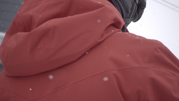 Helmet and jacket of a skier in the swiss alps on a snowy day