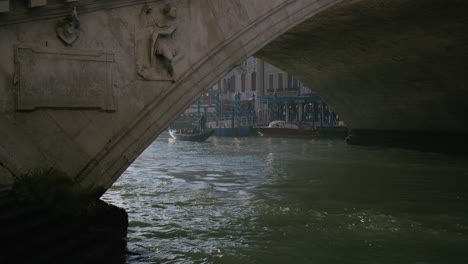 Venetian bridge view with gondola passing by