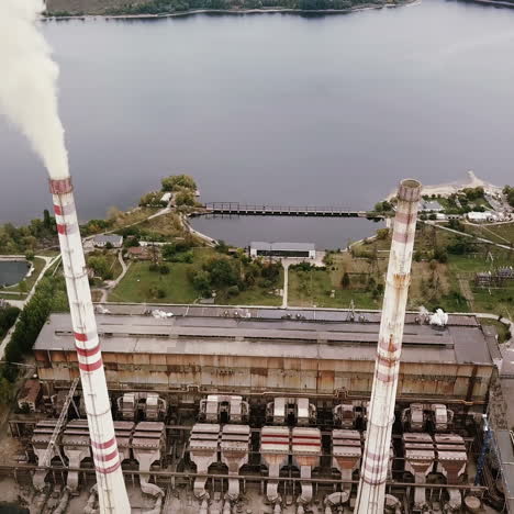 aerial view of coal power station with smoke goes from tubes. view from the birds-eye view.