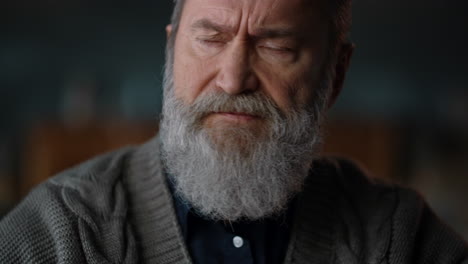 Senior-man-face-closeup.-Old-man-with-crossed-arms-in-cabinet.