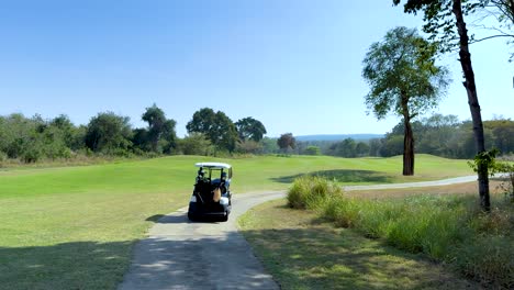 golf cart travels through scenic golf course