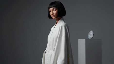 a tranquil portrait of elegance: a fashion model in a minimalistic setting, highlighting modern aesthetics with a unique decorative element