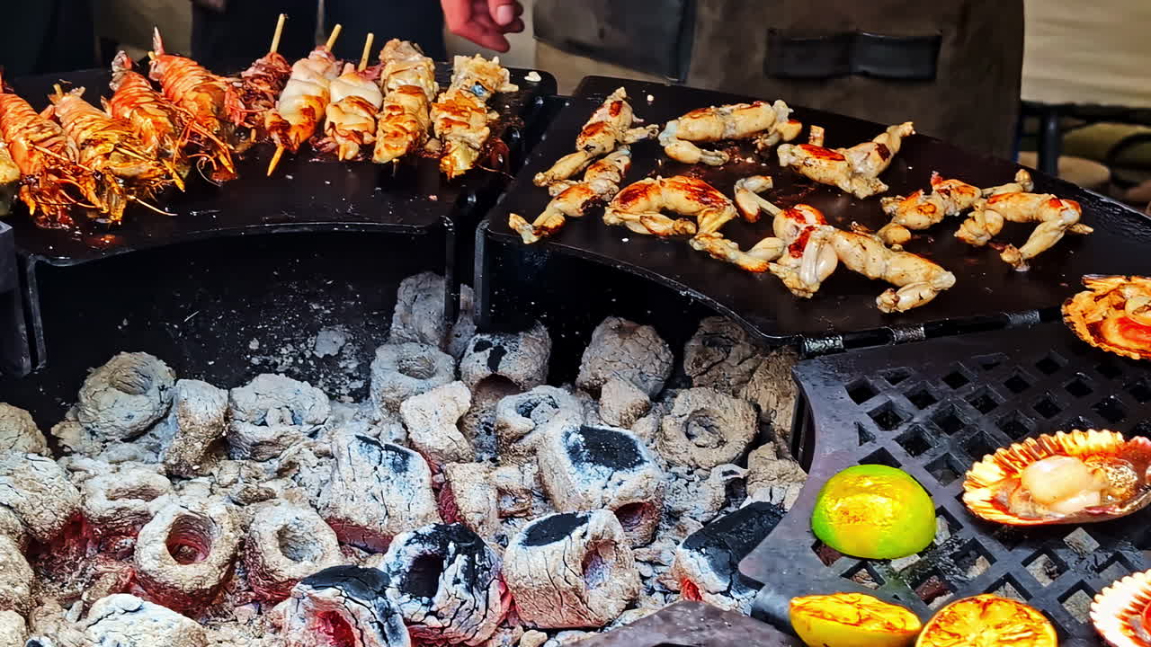 Grilled seafood skewers and oysters cooking over charcoal with peppers and citrus