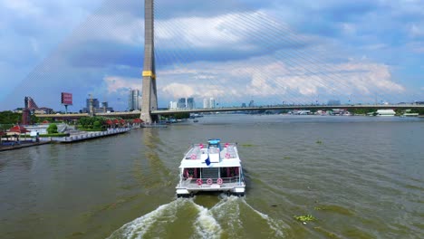 Passenger-Ferry-Ship-Sailing-On-Chao-Phraya-River-Near-Rama-VIII-Bridge-In-Bangkok,-Thailand