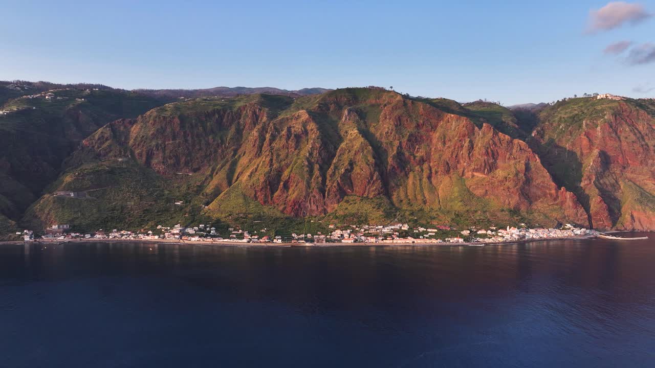 Scenic coastal Paul do Mar fishing village nestled below towering cliffs, drone