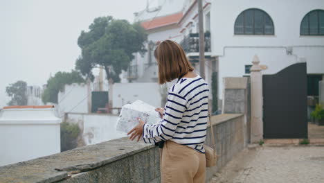 Lost-student-checking-map-in-old-city-vertical-shot.-Unknown-tourist-look-guide