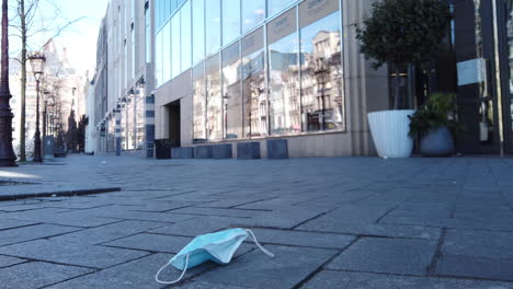 mask flying away on a street in amsterdam during the coronavirus pandemic