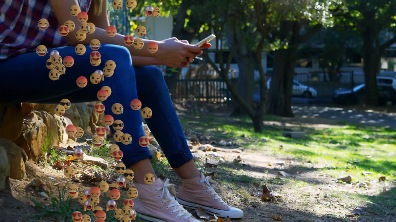 анимация падающих эмодзи над женщиной с помощью смартфона