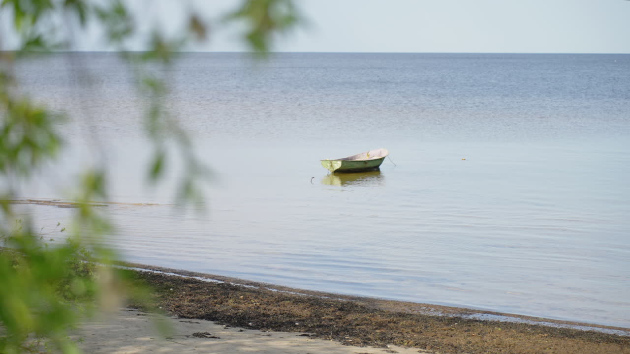 Small boat floating in the Baltic sea shore