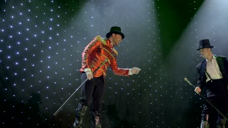 two handsome gentlemen are dancing on stage