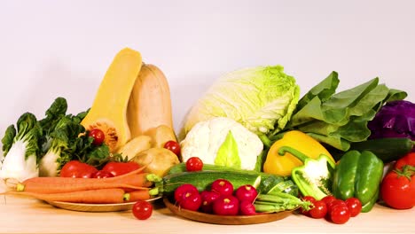 assorted vegetables displayed on a wooden surface